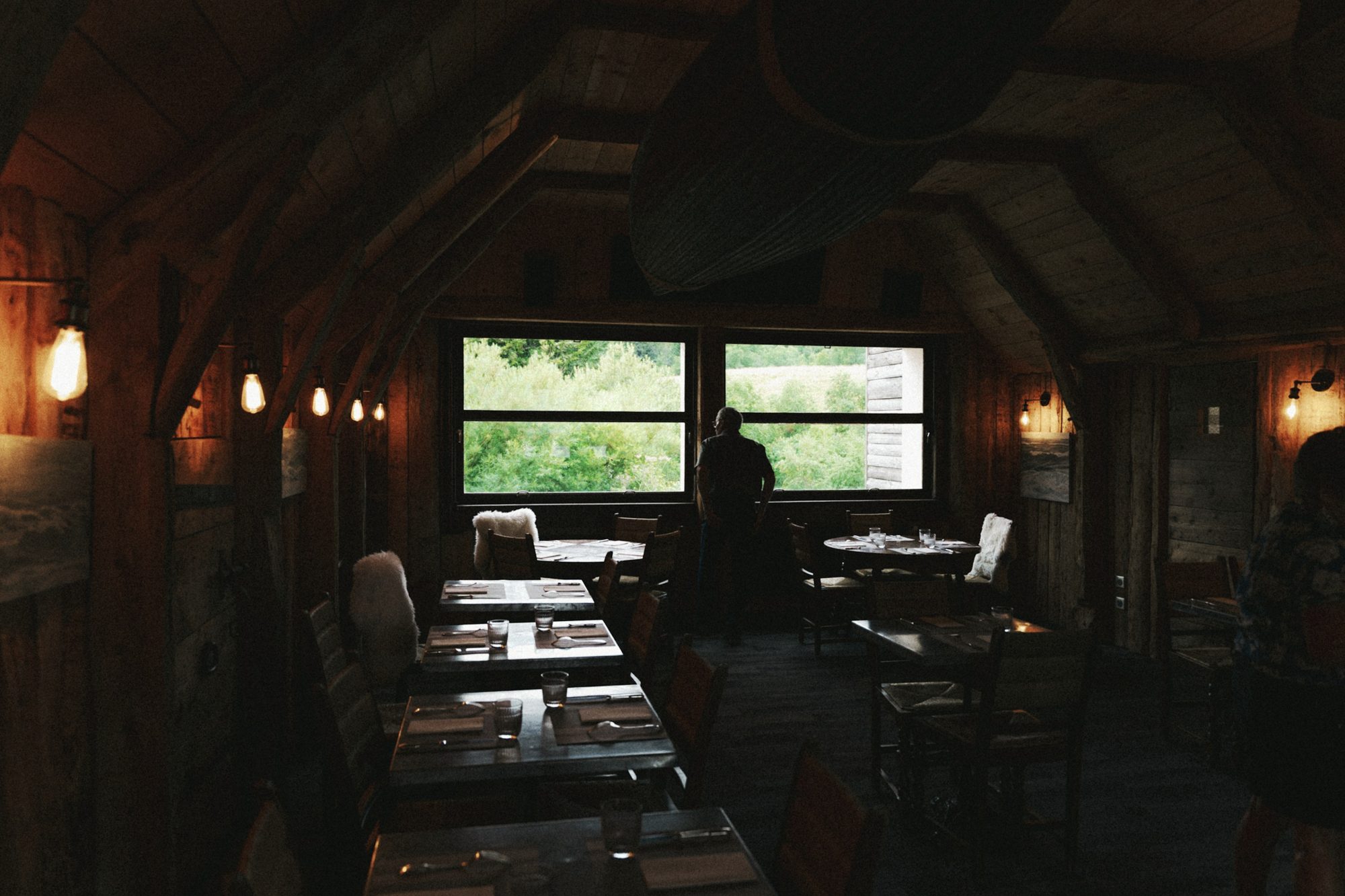 A dining room with daylight through the windows